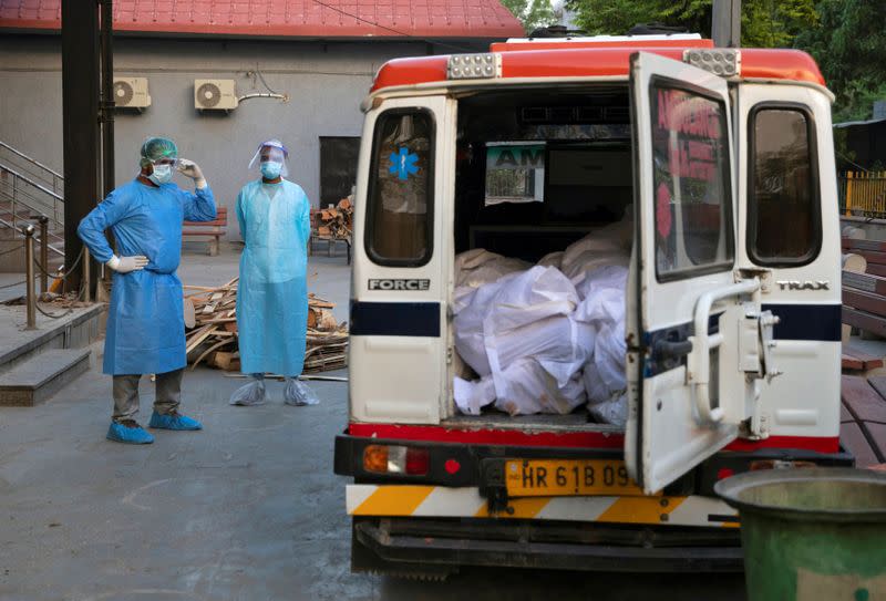 Mohammad Aamir Khan, an ambulance driver, waits for the relatives to unload the bodies of people who died due to the coronavirus disease for their cremation at a crematorium in New Delhi