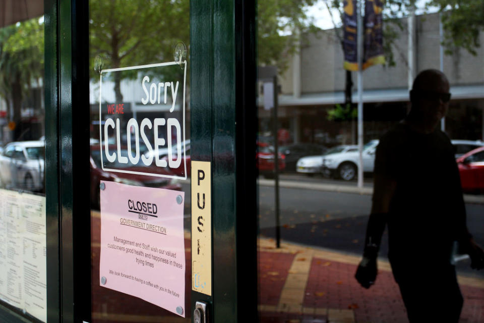 TAMWORTH, AUSTRALIA - APRIL 04: A man walks past closed retail stores along Peel Street on April 04, 2020 in Tamworth, Australia. (Photo by Lisa Maree Williams/Getty Images)