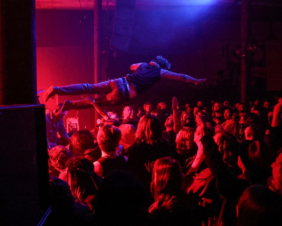 A concert goer leaps off the stage during the Vended show at Wooly’s in the historic East Village in Des Moines on Sunday, Nov. 19, 2023.