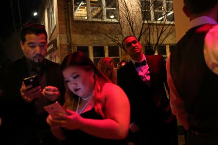 Kumar Srikantappa (Centre R), 31, who is a software architect for Oracle, waits in line to get into a Gatsby-themed party in San Francisco, California, U.S. January 28, 2017. REUTERS/Gabrielle Lurie