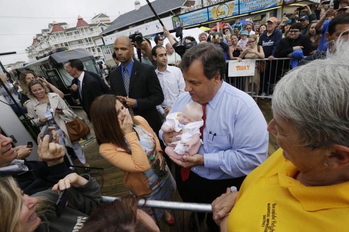 New Jersey Gov. Chris Christie, right, holds 6-week-old Willow DeParre, as first lady Mary Pat Christie looks on as they greet people during the opening of the New Jersey shore, Friday, May 24, 2013, in Seaside Heights, N.J. Christie cut a ribbon to symbolically reopen the state's shore for the summer season, seven months after being devastated by Superstorm Sandy. Several beach communities have annual beach ribbon cuttings, announcing they are back in business. But this year's ceremonies are more poignant seven months after a storm that did an estimated $37 billion of damage in the state. (AP Photo/Julio Cortez)