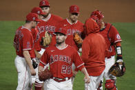 Los Angeles Angels starting pitcher Andrew Heaney, center, leaves the mound and the baseball game during the seventh inning against the Tampa Bay Rays, Thursday, May 6, 2021, in Anaheim, Calif. (AP Photo/Jae C. Hong)