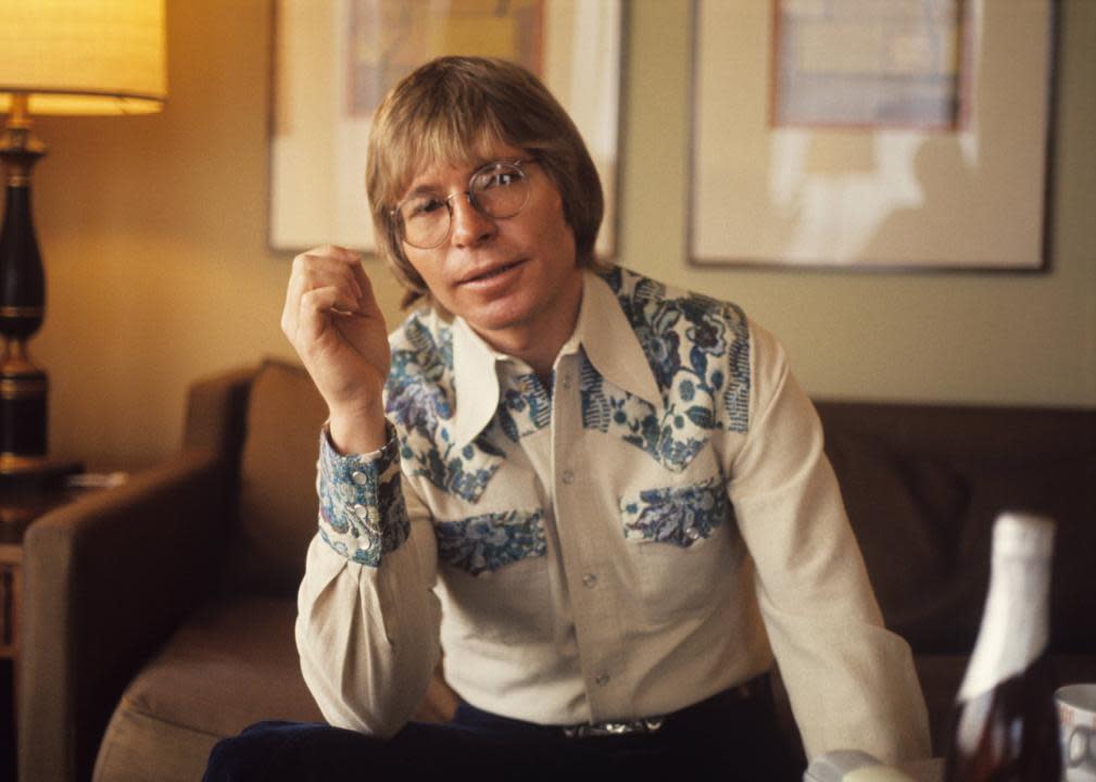 John Denver poses for a portrait in his hotel room.