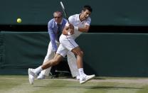 Novak Djokovic of Serbia hits a return during his men's singles final tennis match against Roger Federer of Switzerland at the Wimbledon Tennis Championships, in London July 6, 2014. REUTERS/Suzanne Plunkett