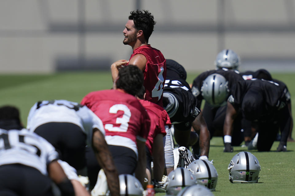 Raiders quarterback Derek Carr warms up during practice at the NFL football team's practice facility Thursday, May 26, 2022, in Henderson, Nev. (AP Photo/John Locher)