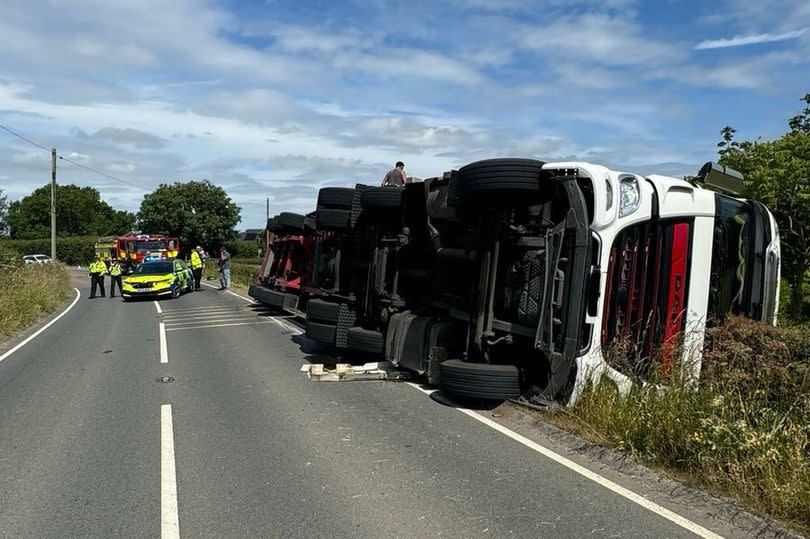 The Street in both directions closed, queueing traffic due to overturned lorry from Braydon Side to School Hill