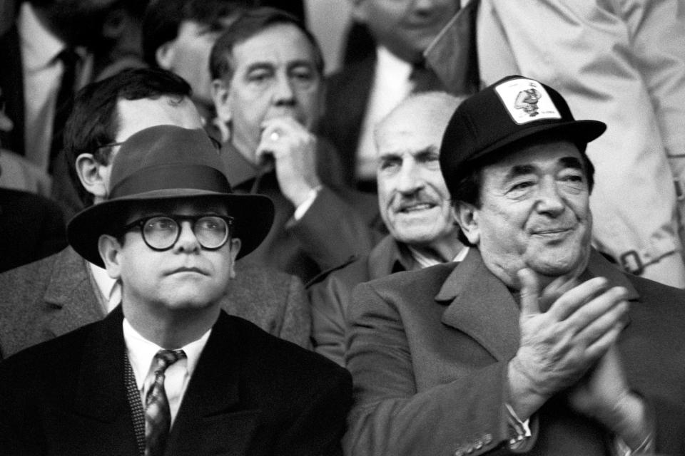 Pop star Elton John, left, who sold his controlling interest in Watford FC to Robert Maxwell for �2 million, joins the publishing tycoon in the stands at Oxford.