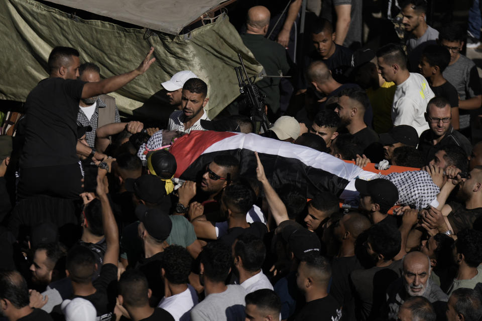 Palestinian mourners carry the body of Tariq Idris, 39, during his funeral, in Askar refugee camp near the West Bank city of Nablus, Saturday, June 24, 2023. Palestinian health officials said that a 39-year-old man, Tariq Idris, died of wounds suffered in violent confrontations with Israeli forces in the northern city of Nablus the day before during an Israeli military arrest raid. (AP Photo/Majdi Mohammed)