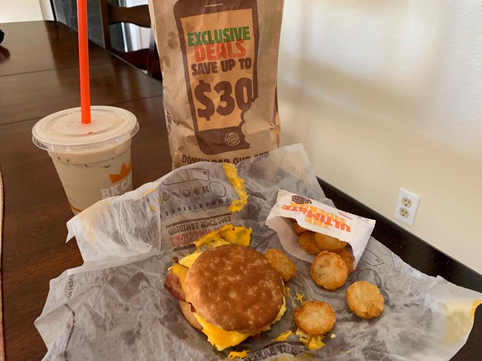 Burger King breakfast spread laid out on a wooden table