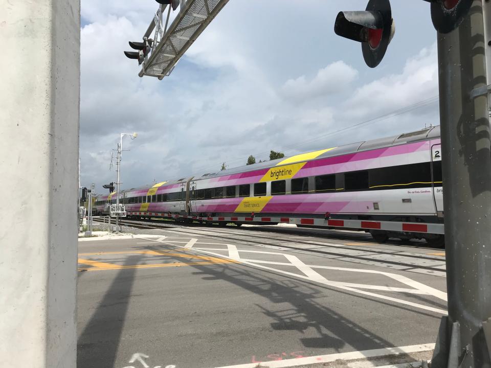 The quad gates stretch across 12th Street in Indian River County as a Brightline train passes on October 12, 2023.