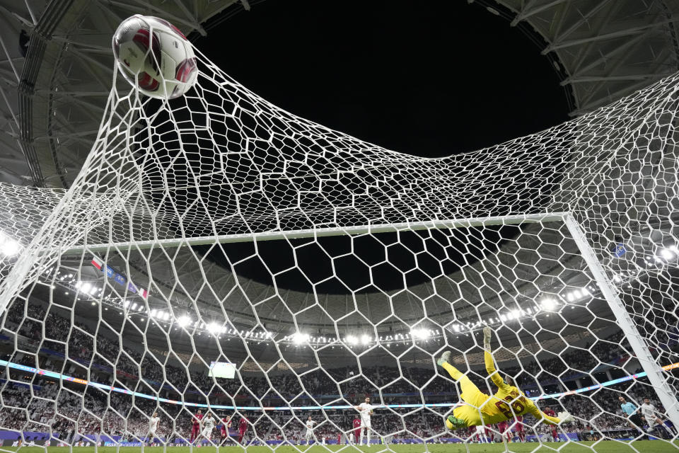 Iran's Alireza Jahan Bakhsh, centre, scores his side's second goal from a penalty kick during the Asian Cup semifinal soccer match between Iran and Qatar at Al Thumama Stadium in Doha, Qatar, Wednesday, Feb. 7, 2024. (AP Photo/Aijaz Rahi)