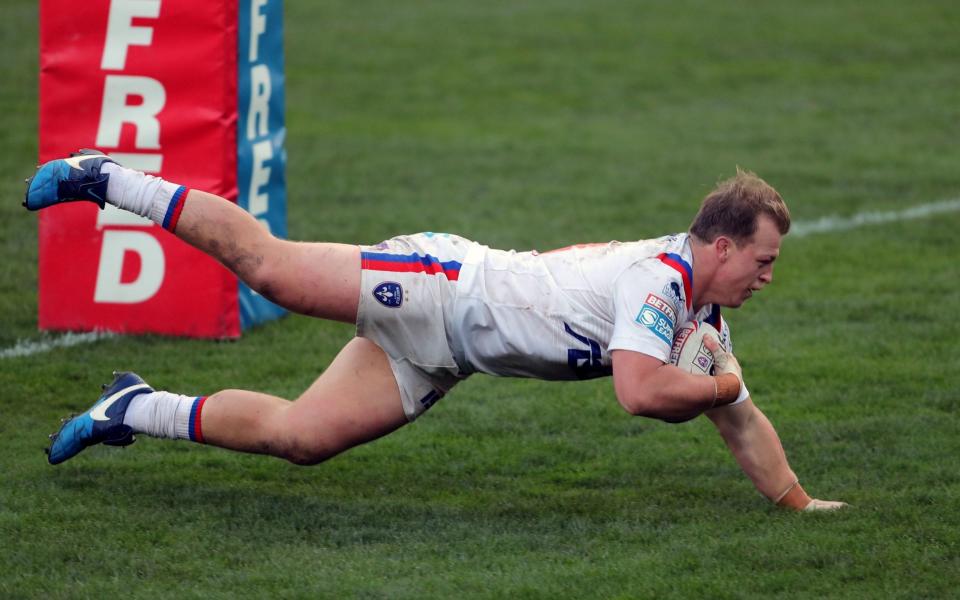 Wakefield Trinity's Eddie Battye crosses the whitewash during his side's easy victory over Hull KR - PA