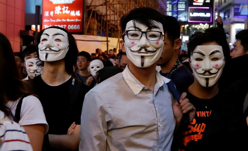 Anti-government protesters wearing costumes march during Halloween in Hong Kong