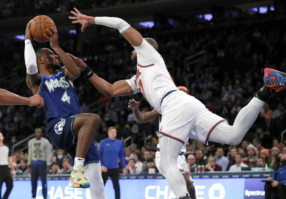 Minnesota Timberwolves guard Jaylen Nowell (4) drives to the basket against New York Knicks center Taj Gibson (67) during the first half of an NBA basketball game, Tuesday, Jan. 18, 2022 in New York. (AP Photo/Noah K. Murray)