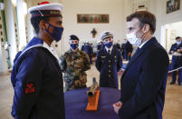 French President Emmanuel Macron meets a cadet prior to his New Year's speech to the French Armed Forces at Brest naval training center, western France, Tuesday, Jan. 19, 2021. (Stephane Mahe/Pool Photo via AP)