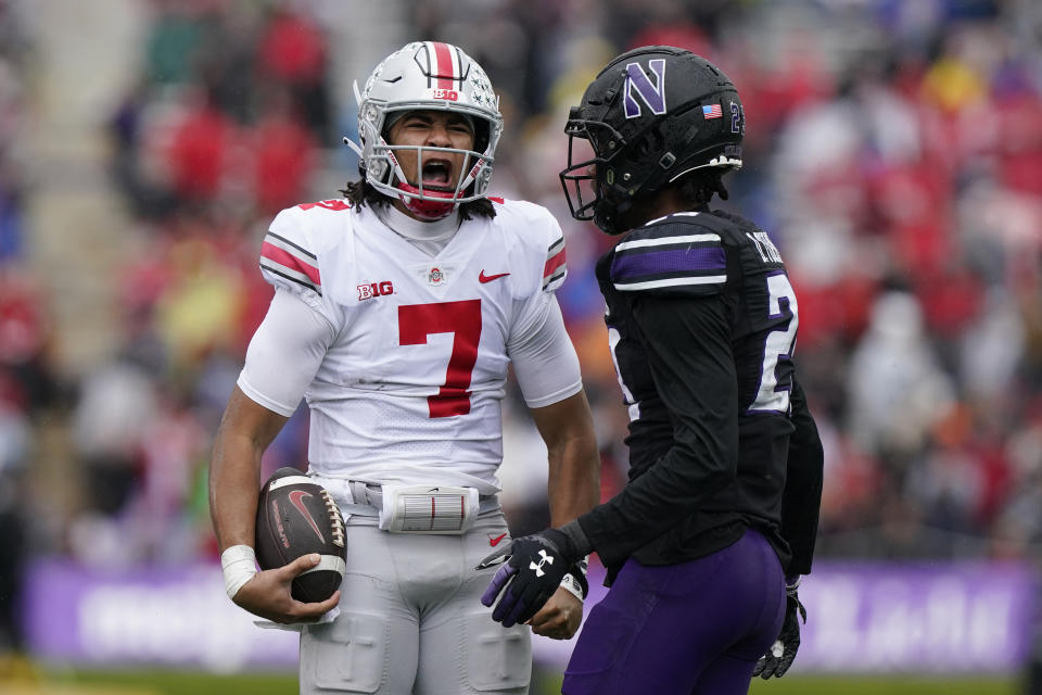 Ohio State quarterback C.J. Stroud, left, reacts after long run against Northwestern defensive back Jack Oyola during the first half of an NCAA college football game, Saturday, Nov. 5, 2022, in Evanston, Ill. Ohio State won 21-7. (AP Photo/Nam Y. Huh)