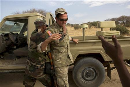 A Nigerien soldier apprehends a U.S. special forces soldier during a mock checkpoint during Flintlock 2014, a U.S.-led international training mission for African militaries, in Diffa, March 5, 2014. REUTERS/Joe Penney