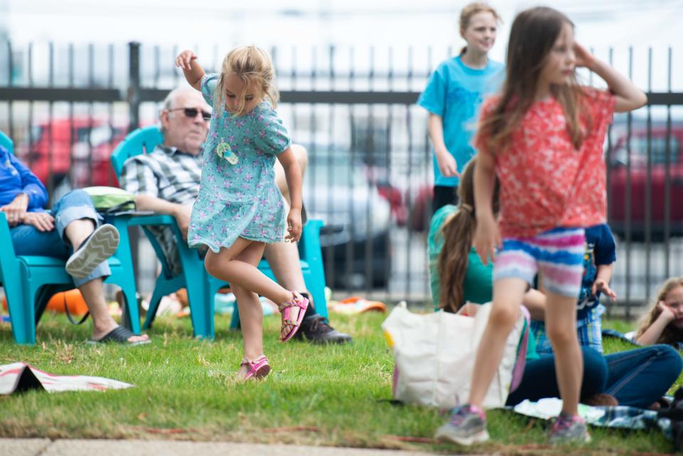 Lydia Barron dances as the Jackson Symphony's "Symphony on the Move" performs outside the Jackson-Madison County Library on Monday, Jun. 12, 2023.