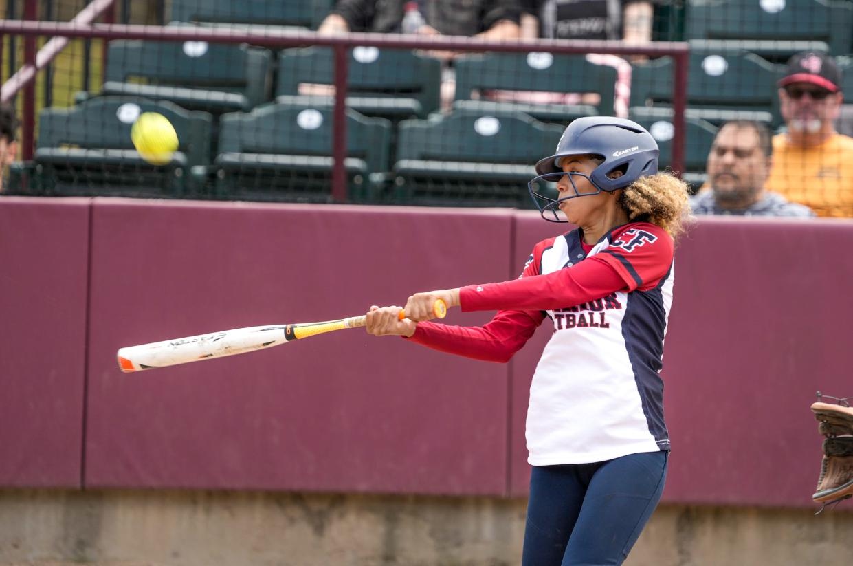 Warrior's catcher Pamela Galva makes contact.