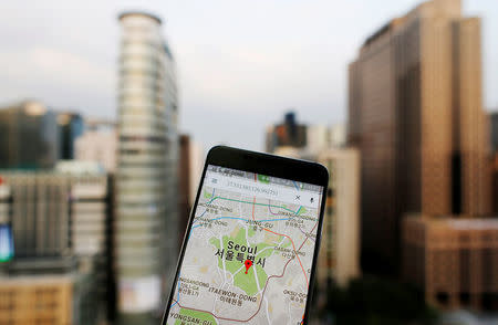 Google Maps application is displayed on a smartphone as central Seoul is seen in the background in Seoul, South Korea, in this photo illustration on August 24, 2016. REUTERS/Kim Hong-Ji