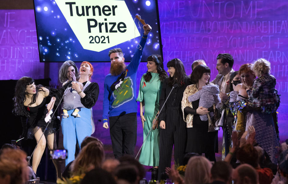 Array Collective are announced as the winner of the Turner Prize 2021, the leading international award for contemporary art, at Coventry Cathedral, Coventry, England, Wednesday Dec. 1, 2021. An 11-person collective from Belfast that aims to transcend Northern Ireland’s political and religious divides has won the U.K.’s prestigious Turner Prize for art. The Array Collective took the 25,000 pound ($33,000) prize on Wednesday for “The Druithaib’s Ball,” a recreation of a traditional Irish shebeen, or speakeasy full of references to 100 years of Northern Ireland history. (Matt Alexander/PA via AP)