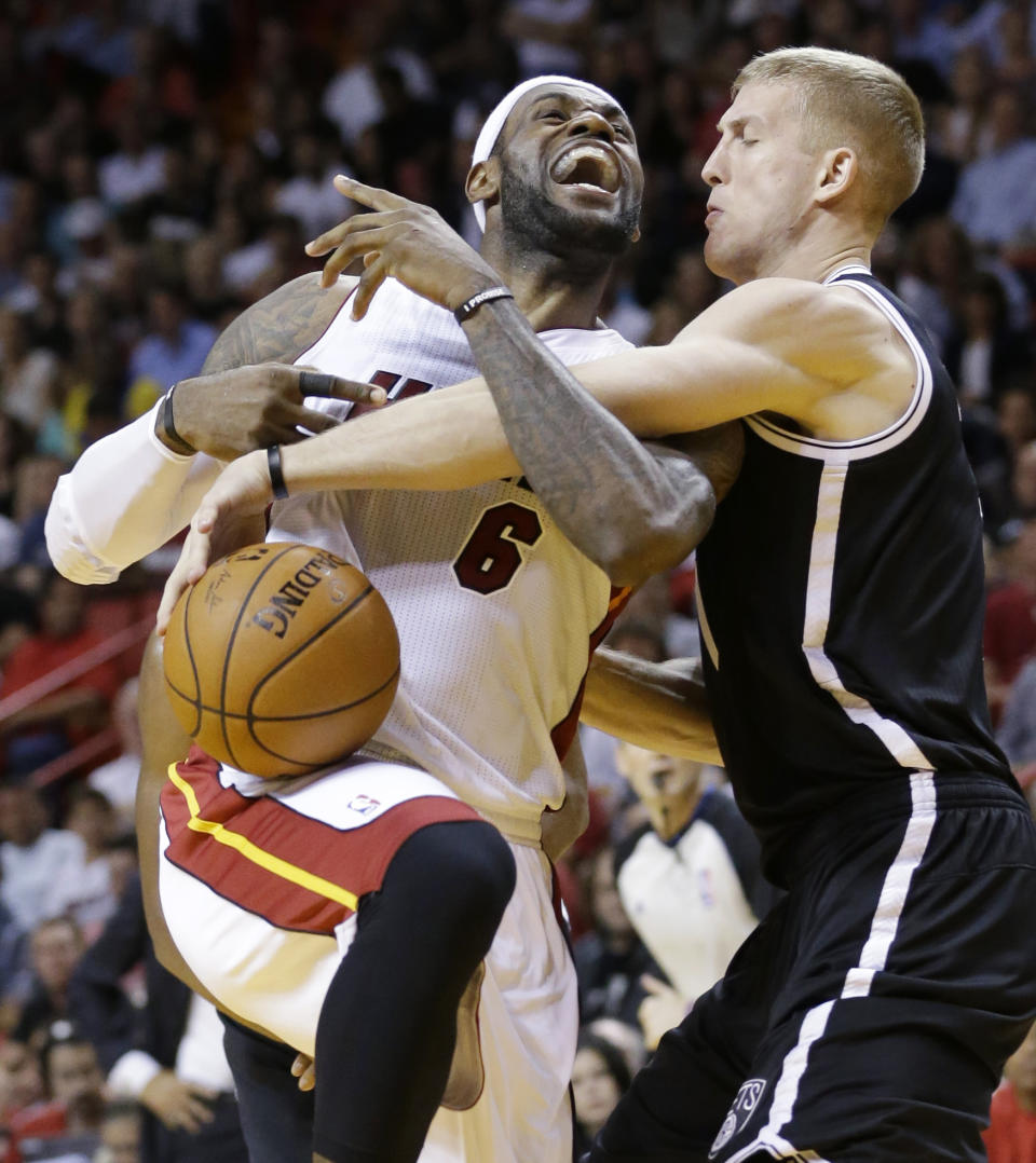 Miami Heat forward LeBron James (6) is fouled by Brooklyn Nets forward Mason Plumlee as he goes up for a shot during the first half of an NBA basketball game, Tuesday, April 8, 2014 in Miami. (AP Photo/Wilfredo Lee)