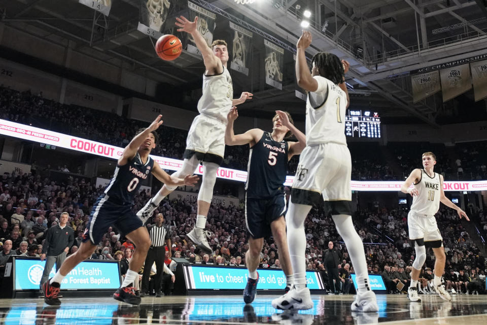 Wake Forest forward Matthew Marsh (33) blocks a shot by Virginia guard Kihei Clark (0) during the second half of an NCAA college basketball game in Winston-Salem, N.C., Saturday, Jan. 21, 2023. (AP Photo/Chuck Burton)