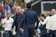 France's head coach Didier Deschamps, left, speaks towards the Argentina bench during the World Cup final soccer match between Argentina and France at the Lusail Stadium in Lusail, Qatar, Sunday, Dec. 18, 2022. (AP Photo/Martin Meissner)