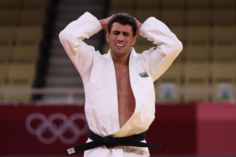 <p>Azerbaijan's Rustam Orujov (white) reacts after losing to South Korea's An Changrim in the judo men's -73kg bronze medal A bout during the Tokyo 2020 Olympic Games at the Nippon Budokan in Tokyo on July 26, 2021. (Photo by Jack GUEZ / AFP) (Photo by JACK GUEZ/AFP via Getty Images)</p> 