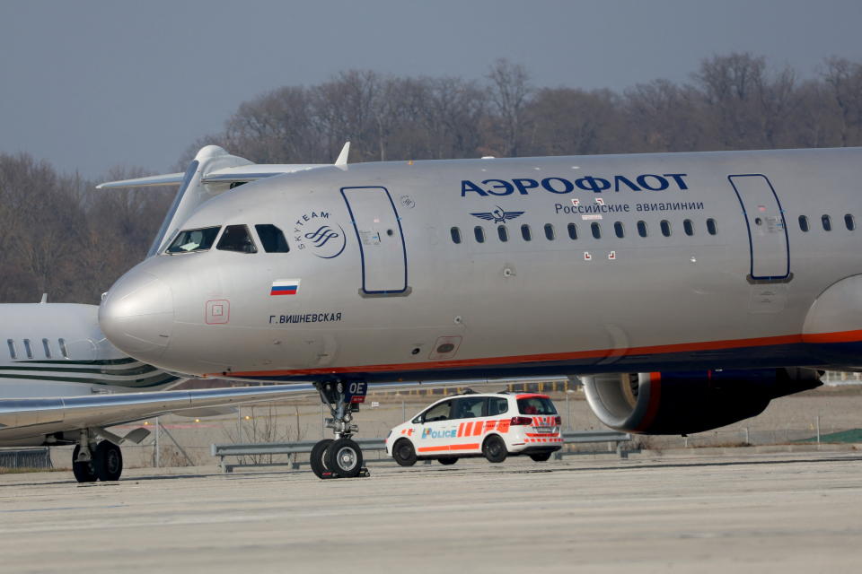 A police vehicle drives behind an Airbus A321-211 aircraft of Russian airline Aeroflot with registration VP-BOE on a long term parking at Cointrin airport in Geneva, Switzerland, March 9, 2022. REUTERS/Denis Balibouse