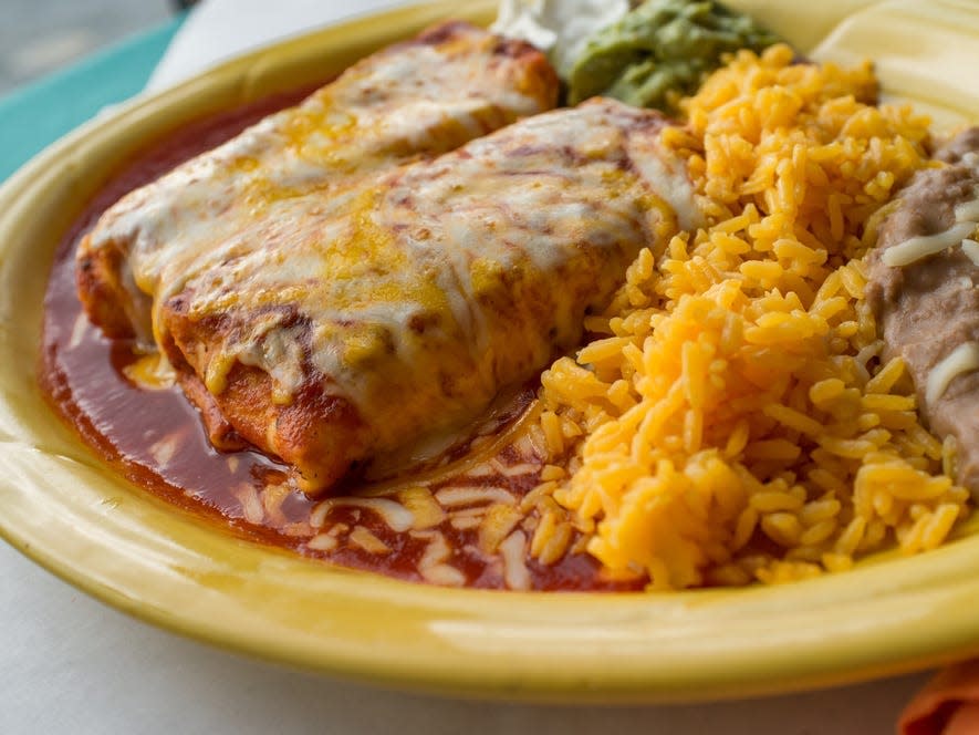 Chimichangas on a plate with rice and sauce