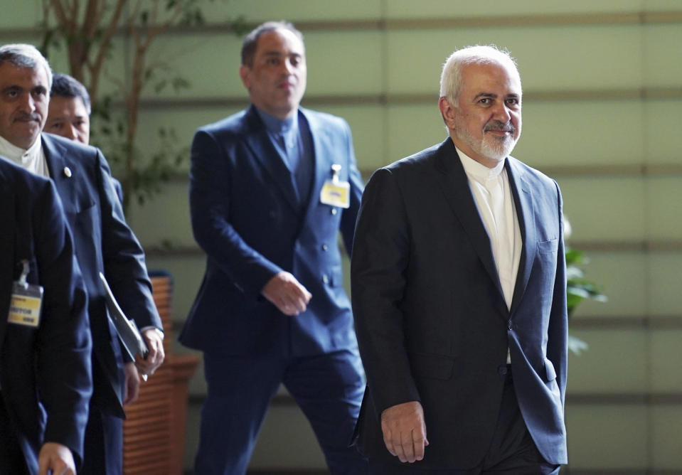 Iranian Foreign Minister Mohammad Javad Zarif, right, walks to meet Japanese Prime Minister Shinzo Abe at Abe's official residence in Tokyo Thursday, May 16, 2019. Iran’s foreign minister has said his country is committed to an international nuclear deal and criticized escalating U.S. sanctions “unacceptable” as he met with Japanese officials in Tokyo amid rising tensions in the Middle East.(AP Photo/Eugene Hoshiko, Pool)