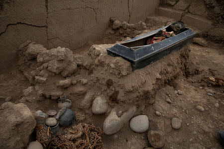 The tomb of one of sixteen Chinese migrants, discovered buried at the turn of the 20th century in the pre-colombian pyramid of Bellavista, is seen in Lima, Peru, August 24, 2017. REUTERS/Mariana Bazo