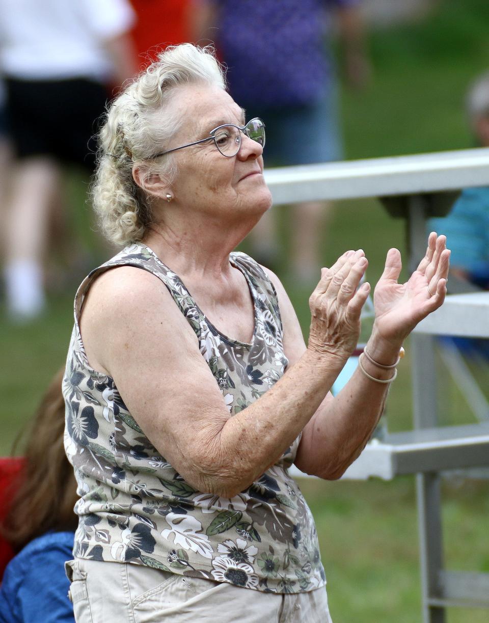 Vonda Miller claps and dances to The John Hampu Band during holiday festivities July 4, 2022, at Silver Park in Alliance.