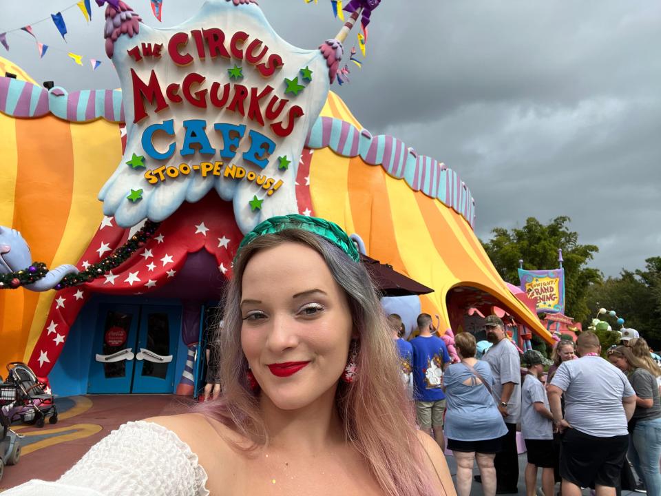 jenna posing outside dr suess themed dining area at universal