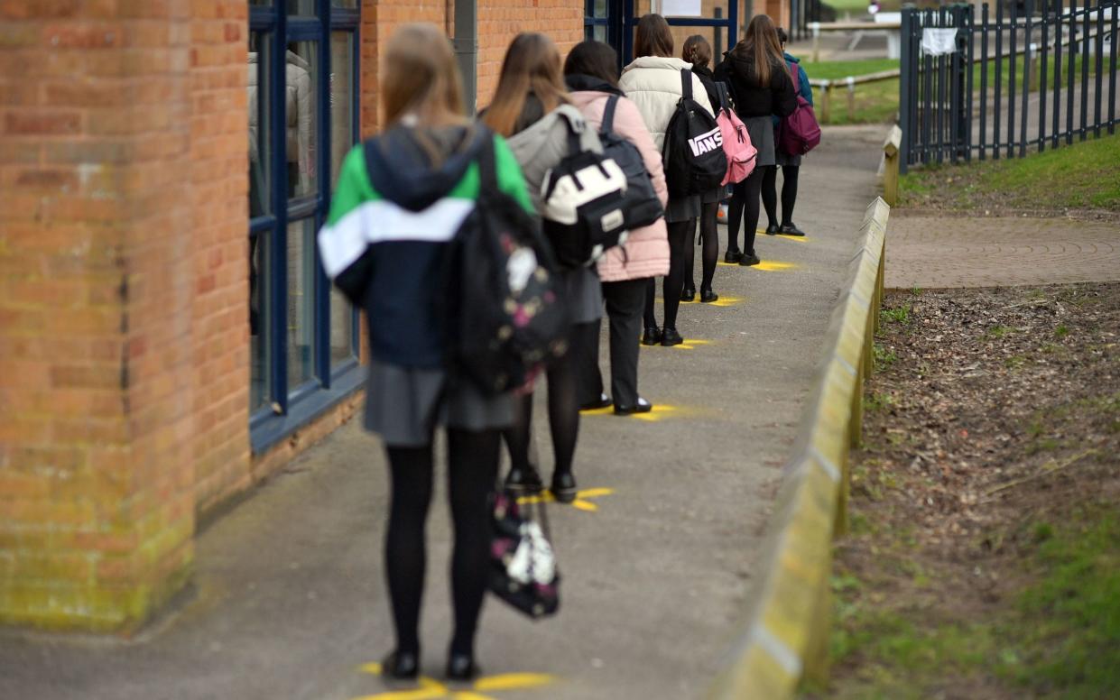 Pupils at a school in Gloucestershire queue to take lateral flow tests earlier this year - Ben Birchall/PA