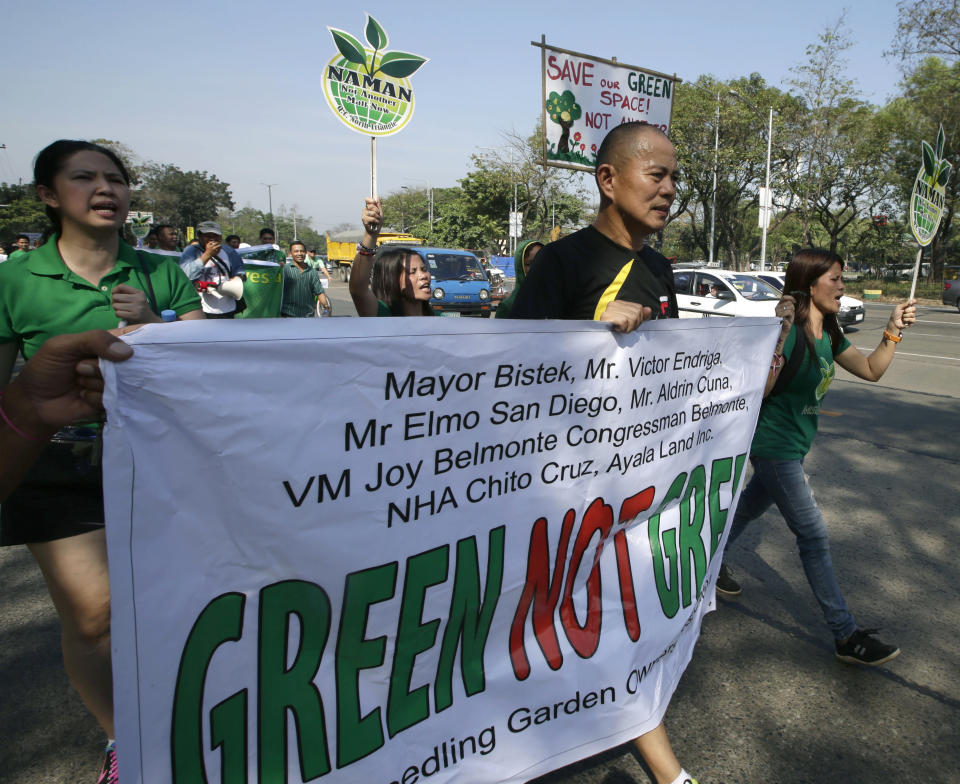 In this Feb. 20, 2014 photo, Roman Catholic priest Father Robert Reyes, second right, jogs with supporters during a protest against the demolition of an informal settlers community that will pave the way for the construction of shopping malls in Quezon city northeast of Manila, Philippines. For more than 30 years, Reyes, dubbed the “running priest” by the local media, has been a constant critic of corruption in the Philippines and often times the church itself, which he charges has abandoned its obligation to help the poor and sided with those in power in Asia’s largest Roman Catholic nation. (AP Photo/Bullit Marquez)