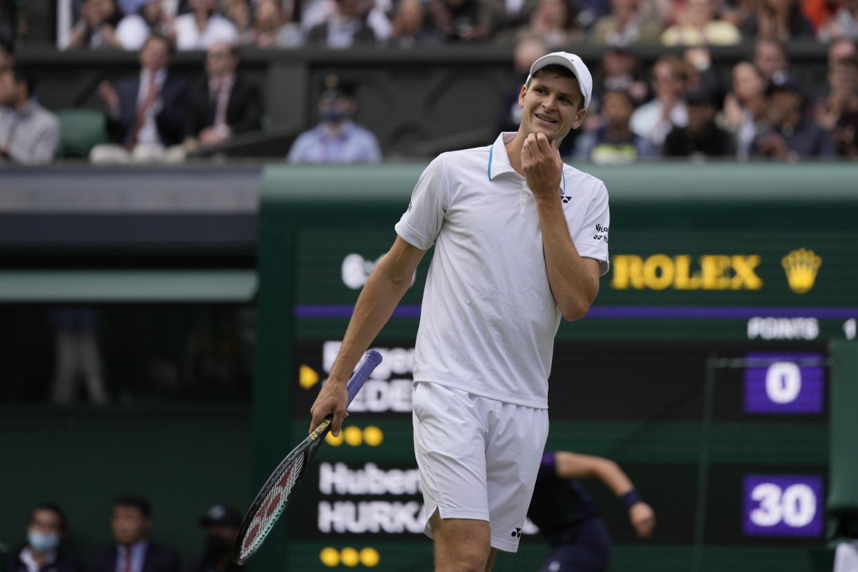 Poland's Hubert Hurkacz reacts during the men's singles quarterfinals match against Switzerland's Roger Federer on day nine of the Wimbledon Tennis Championships in London, Wednesday, July 7, 2021. (AP Photo/Kirsty Wigglesworth)