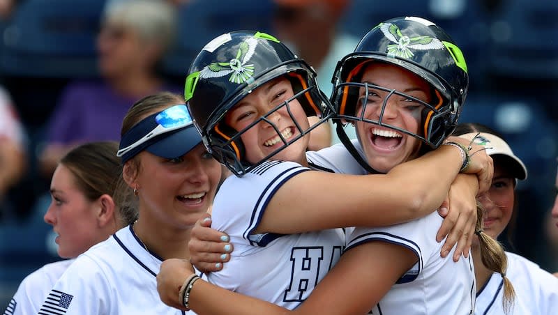 Ridgeline’s Ellie Pond (15), right, is congratulated by Ava Buttars after Pond hit it out of the park in the 4A softball state finals game against Desert Hills at Miller Park in Provo on Friday, May 17, 2024.