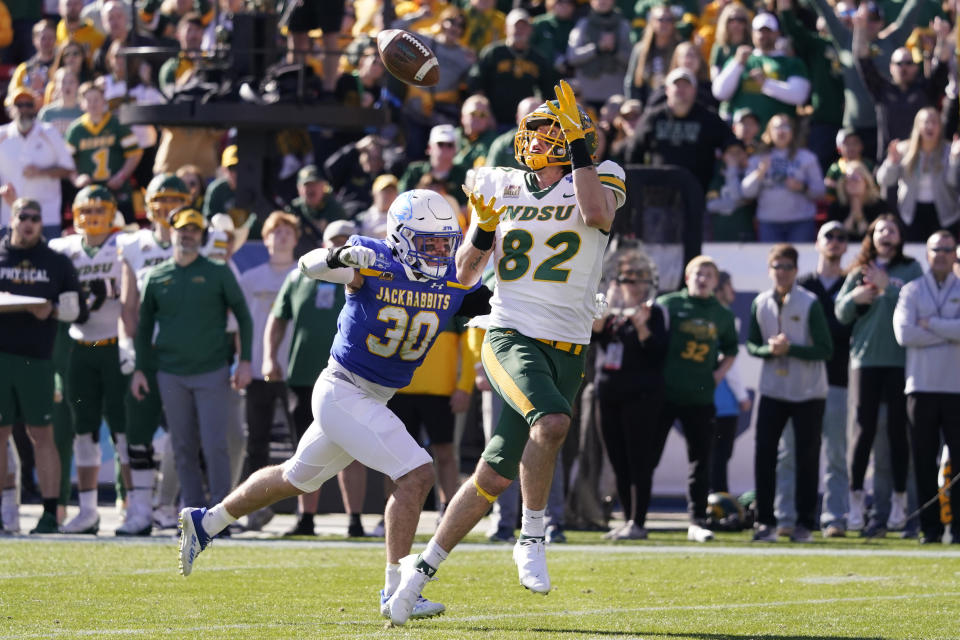 CORRECTS TO NORTH DAKOTA STATE NOT NORTH DAKOTA - North Dakota State tight end Joe Stoffel (82) catches a touchdown pass in front of South Dakota State linebacker Payton Shafer (30) during the first half of the FCS Championship NCAA college football game Sunday, Jan. 8, 2023, in Frisco, Texas. (AP Photo/LM Otero)