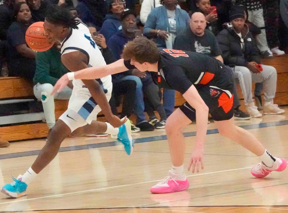 Nicolet senior Nacir Beamon (4) pushes the ball up the court over Grafton senior Michael McNabb Jr.,(12) during the first half of their game Tuesday, Dec. 12, 2023, against Grafton at Nicolet High School in Glendale, Wisconsin. Ebony Cox / Milwaukee Journal Sentinel