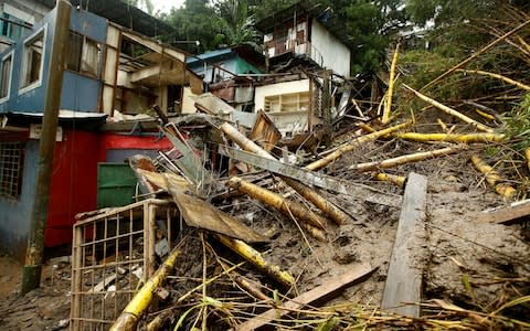 Houses damaged by a mudslide are seen during heavy rains of Tropical Storm Nate that affects the country in San Jose, Costa Rica - Credit: Reuters