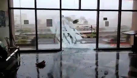 A glass door shatters during Cyclone Fani in Bhubaneswar, Odisha, India May 3, 2019 in this still image taken from a video obtained from social media. AMAN PRATAP SINGH/via REUTERS
