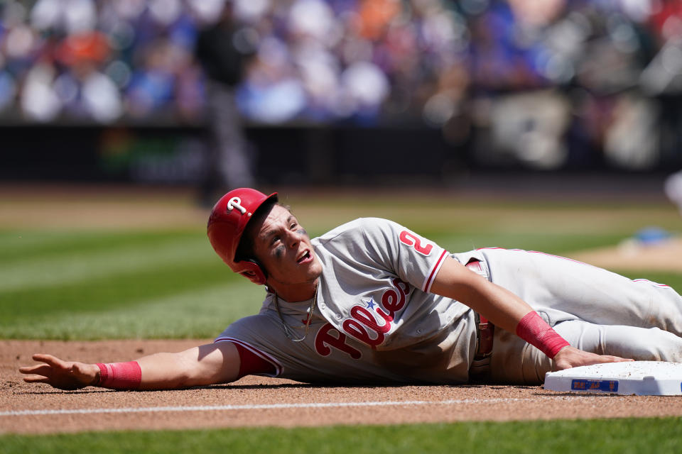 Philadelphia Phillies' Nick Maton reacts at third base after diving back for an attempted putout during the second inning of a baseball game against the New York Mets, Sunday, June 27, 2021, in New York. Maton was initially ruled out but found to be safe after a video review. He scored on Odubel Herrera's sacrifice fly. (AP Photo/Kathy Willens)