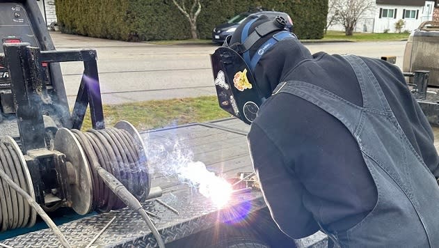 A student at Hope Secondary School in Hope, BC uses a portable welding unit donated by Enbridge.