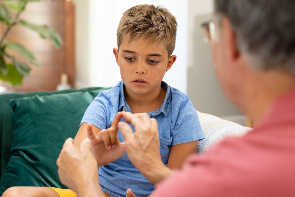 Child trust fund: child being taught sign language