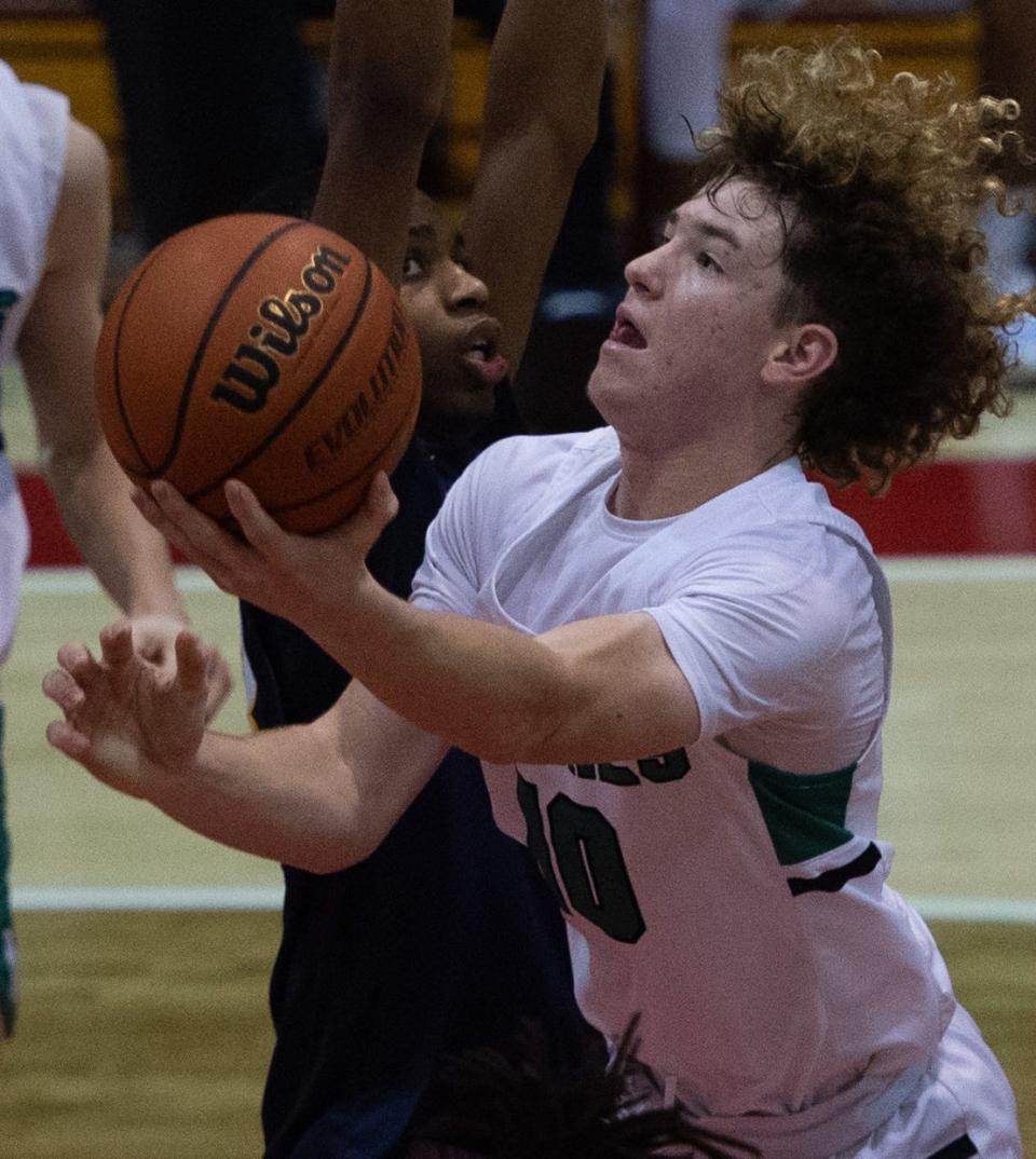 North’s Brayden Huebner (10) drives the ball to the net as he’s defended by Springfield Southeast’s Marquez Small (43) during the Bosse Winter Classic at Bosse High School in Evansville, Ind., Saturday afternoon, Dec. 17, 2022. 