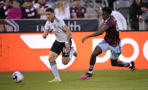 San Jose Earthquakes forward Cristian Espinoza, left, and Colorado Rapids defender Moïse Bombito pursue the ball during the first half of an MLS soccer match Saturday, June 3, 2023, in Commerce City, Colo. (AP Photo/David Zalubowski)