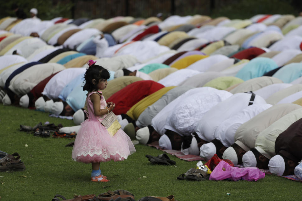 <p>An Indian Muslim girl watches elders offer Eid al-Adha prayers at the 14th century Feroz Shah Kotla Jami Mosque in New Delhi, India, Saturday, Sept. 2, 2017. (Photo: Tsering Topgyal/AP) </p>