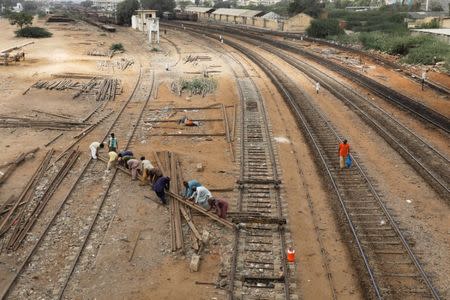 Labourers from the Pakistan Railways are seen working on railway tracks along City Station in Karachi, Pakistan September 24, 2018. REUTERS/Akhtar Soomro